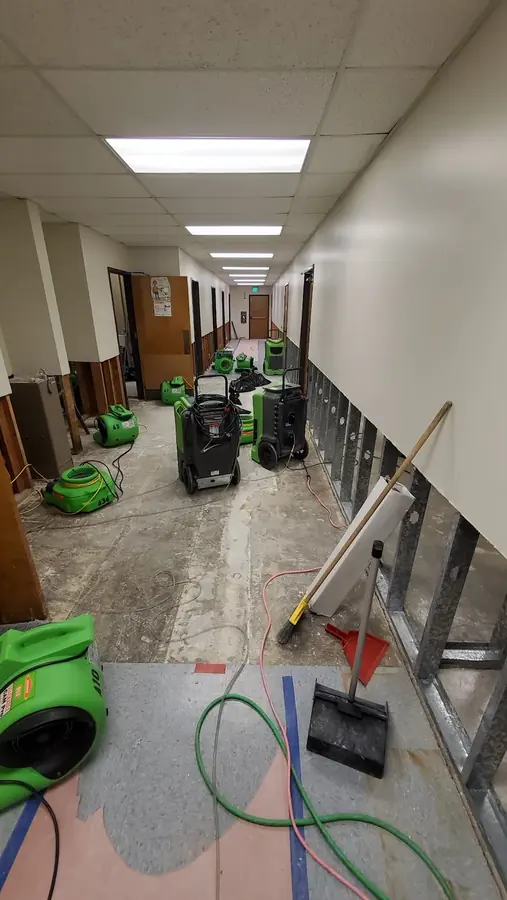 Air movers drying a water damaged corridor in Hawaiian Gardens